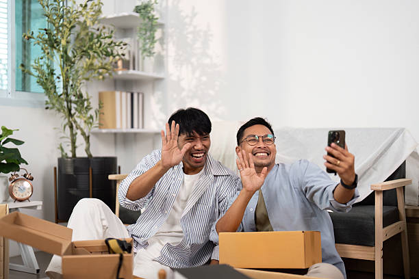istock Gay couple capturing memories with a selfie while unpacking 2221101186