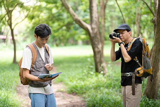 istock Father and Son Capturing Memories. Hiking with a camera and map. 2221101367