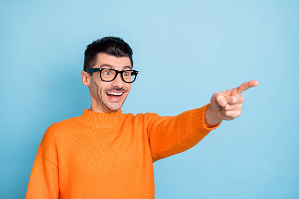 istock Profile photo of impressed guy open mouth smile look interested direct finger empty space isolated on blue color background 2221102827
