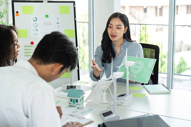istock ESG and Sustainability Discussion. Team collaborating on environmental strategies in a modern workspace. 2221102914