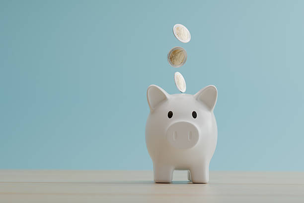 istock front view white piggy bank with coins falling. save money concept. 2221105951