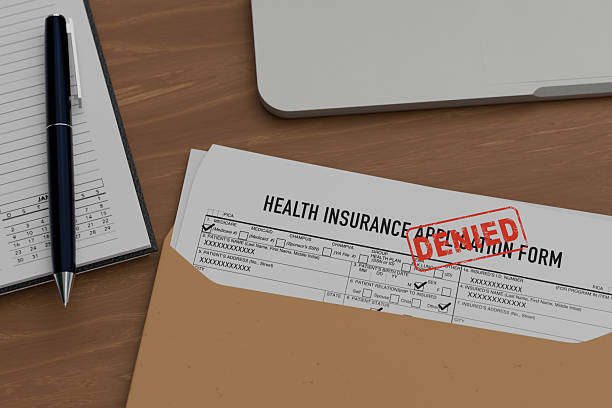 istock denied insurance form on wooden table. 2221106389