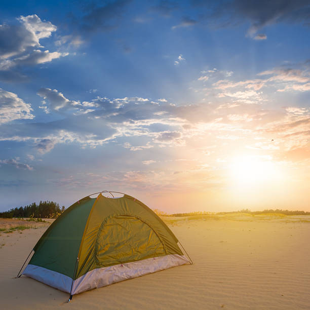 istock closeup small touristic tent stay among sandy desert at the dramatic sunset 2221111110