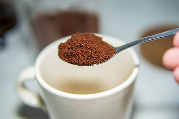 istock A spoonful of ground coffee held above a white ceramic mug. 2221112178