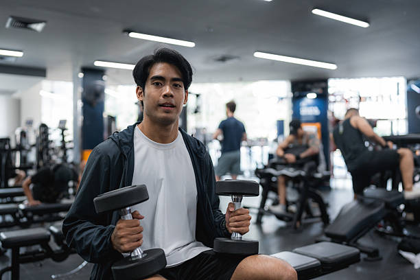 istock Fit Man Lifting Weights During an Intense Workout Session at the Gym 2221114373