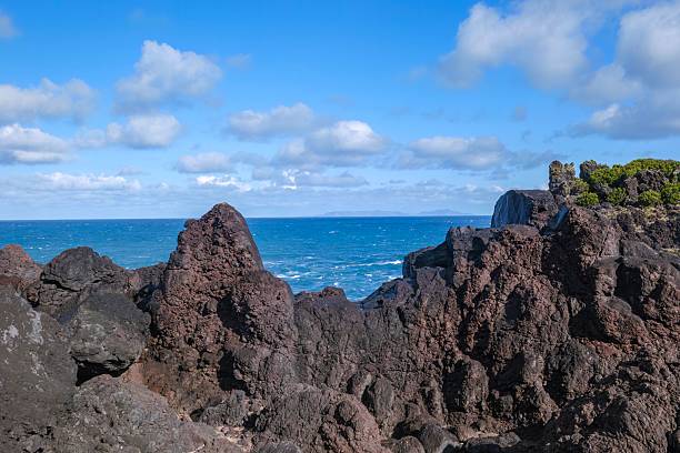 istock Rugged Volcanic Rock Formations Along a Dramatic Coastline Under a Bright Blue Sky. Black Lava, Atlantic Ocean, Natural Landscape, Coastal Scenery, travel, geological, and adventure tourism 2221115445