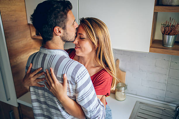 istock Young Couple Finding Joy in a Quiet Hug in Kitchen 2221115726
