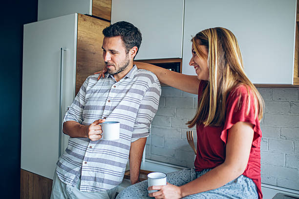 istock Young couple enjoying morning coffee in kitchen 2221115792
