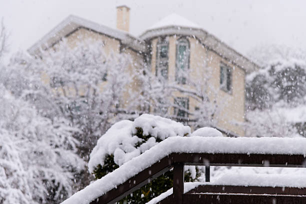 The roof of the house in winter is covered with snow. High quality photo
