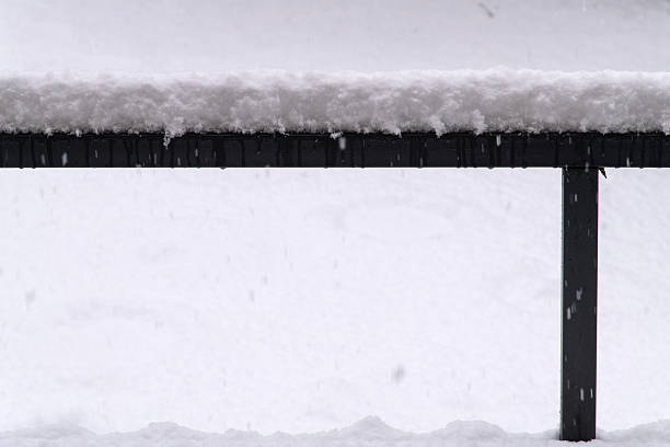 istock snow-covered guardrail at the balcony on a snowy day 2221115906
