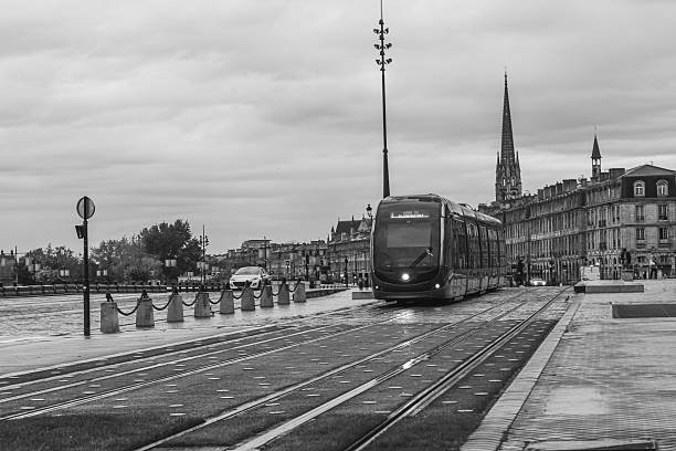 Sleek, modern tram is passing through a bordeaux cityscape, showcasing the city's blend of historical and contemporary architecture