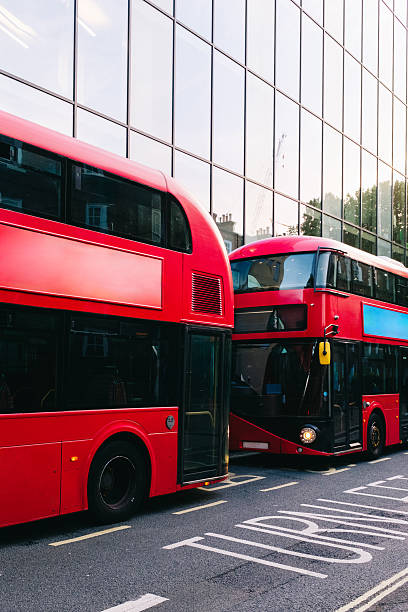 istock Two red double-decker buses parked on london street 2221122314
