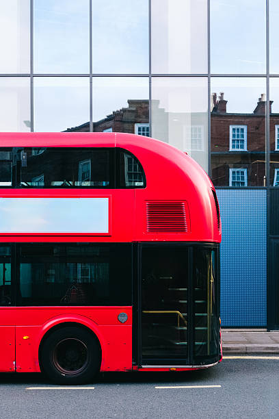 istock Red double decker bus parked near modern building in london 2221122340