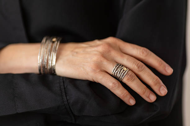 Woman jewelry designer is showing beautiful ring and bracelet that she designed.