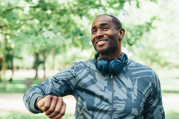 istock Young man checking progress on smartwatch outdoors 2221131426