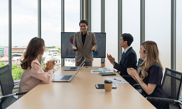 istock Enthusiastic diverse corporate team applauding in a meeting around a conference table, embodying collective decision making. 2221132422