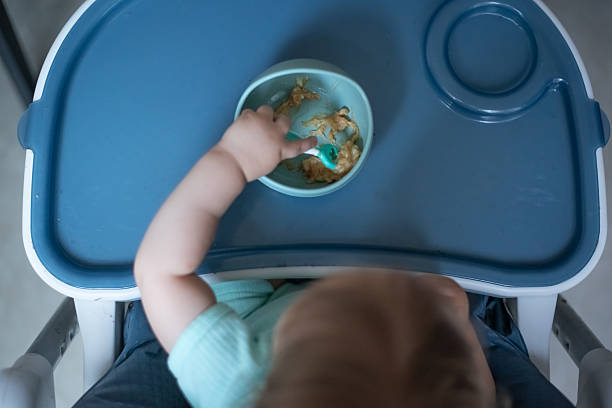 istock Baby eating mashed banana with autonomy 2221133815