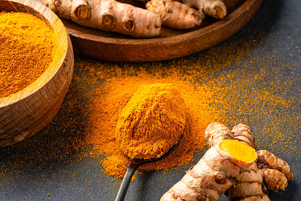 istock Turmeric with its magnificent orange color on a vintage black background 2221136050