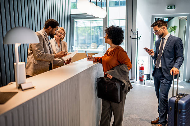 istock Businesspeople checking in at hotel reception 2221136075