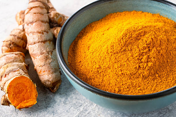 istock Turmeric with its magnificent orange color on a vintage white background 2221136086