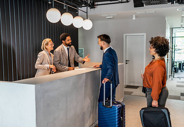 istock Businesspeople arriving at hotel reception for check in 2221136337