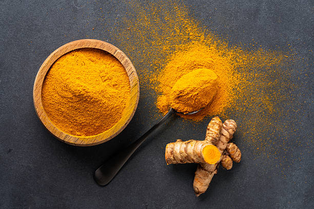 istock Turmeric with its magnificent orange color on a vintage black background 2221136357