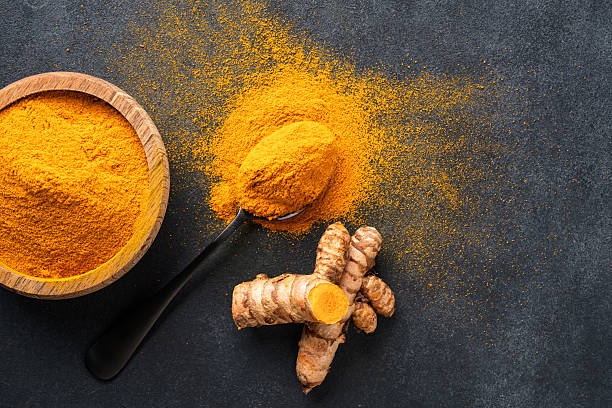 istock Turmeric with its magnificent orange color on a vintage black background 2221136410