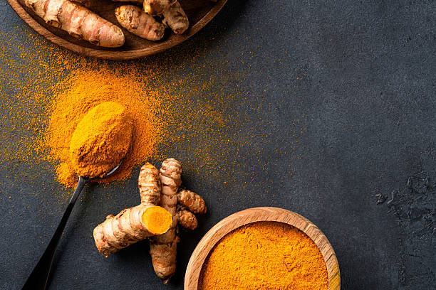 istock Turmeric with its magnificent orange color on a vintage black background 2221136445