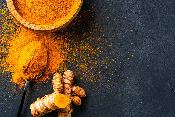 istock Turmeric with its magnificent orange color on a vintage black background 2221136514