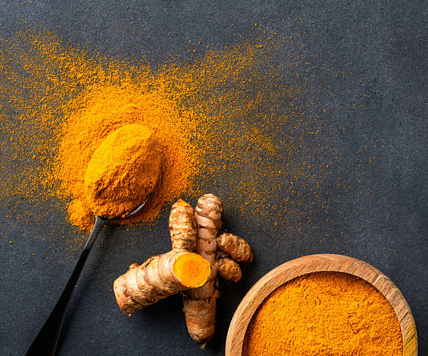 istock Turmeric with its magnificent orange color on a vintage black background 2221136861