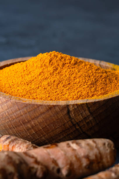 istock Turmeric with its magnificent orange color on a vintage black background 2221136862
