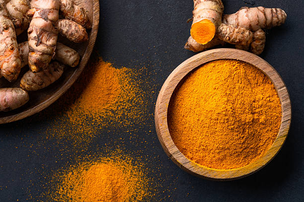 istock Turmeric with its magnificent orange color on a vintage black background 2221136863