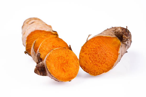 Turmeric with its magnificent orange color on a white background