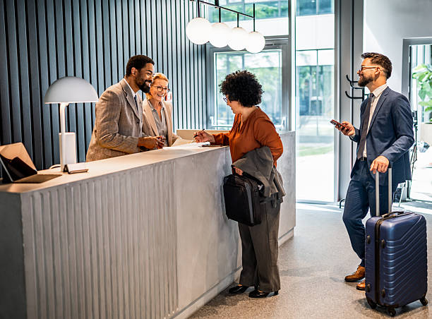 istock Businesswoman checking in at hotel reception desk 2221137743