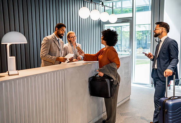 istock Businesswoman making check-in at hotel reception desk 2221138179