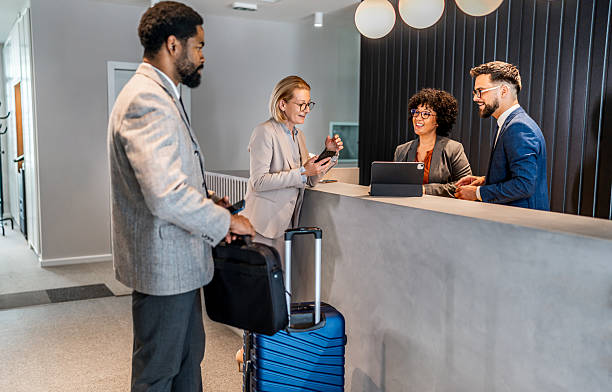 istock Businesspeople checking in at hotel reception 2221138347