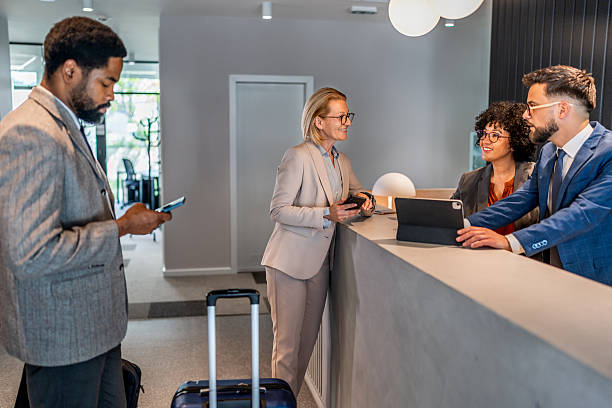 istock Businesspeople checking in at hotel reception 2221138377