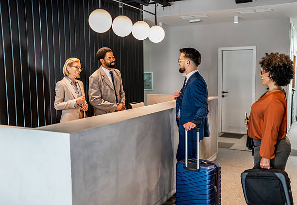 istock Businesspeople arriving at hotel reception are doing the check-in 2221138518