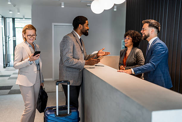 istock Businesspeople checking in at hotel reception 2221138549