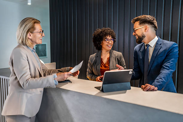 istock Businesspeople checking in at hotel reception 2221138589