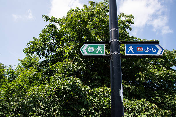 istock Directional sign for the London Loop walking trail and Route 12 cycle path, featuring walking and bicycle symbols in Enfield, London. 2221138626