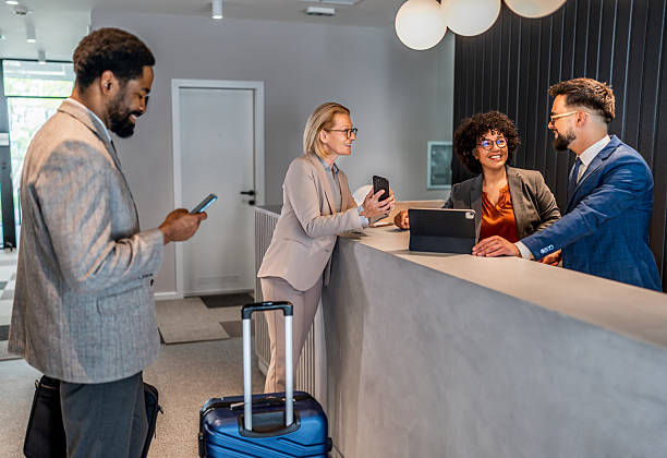 istock Businesspeople checking in at hotel reception 2221138773