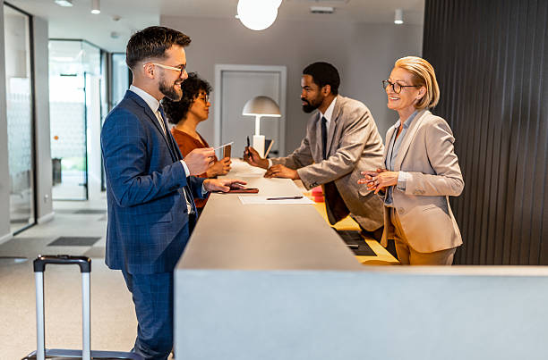 istock Businesspeople checking in at hotel reception 2221138876