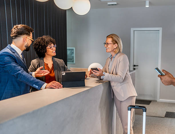 istock Businesspeople checking in at hotel reception 2221139213