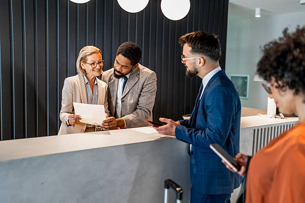 istock Businesspeople checking in at hotel reception 2221139251