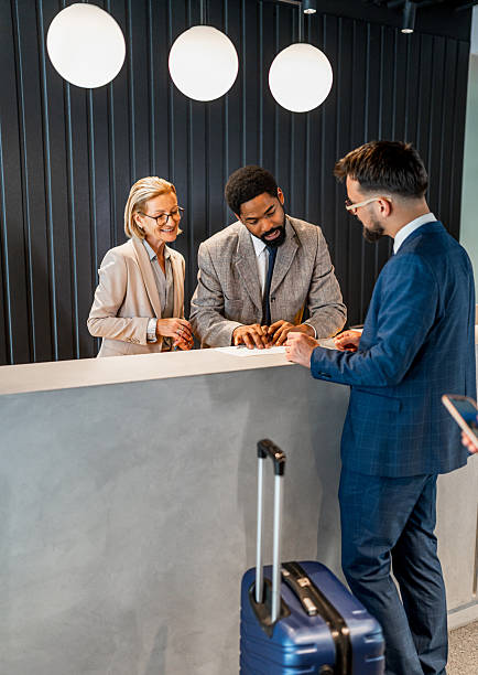 istock Businessman checking in at hotel reception 2221139360