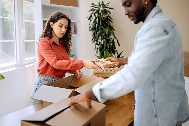istock Young couple packing boxes in their new home 2221141860
