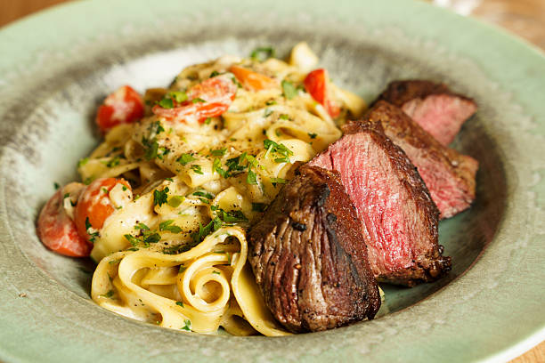 istock Creamy tagliatelle with grilled steak and cherry tomatoes 2221143684