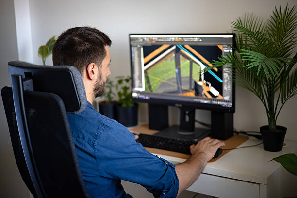 istock Man working on a laptop at a desk surrounded by indoor plants 2221147287