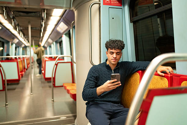 istock Teenager sitting using smartphone on the metro 2221147938